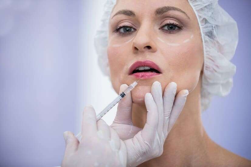 woman-with-marked-face-receiving-botox-injection_107420-74123