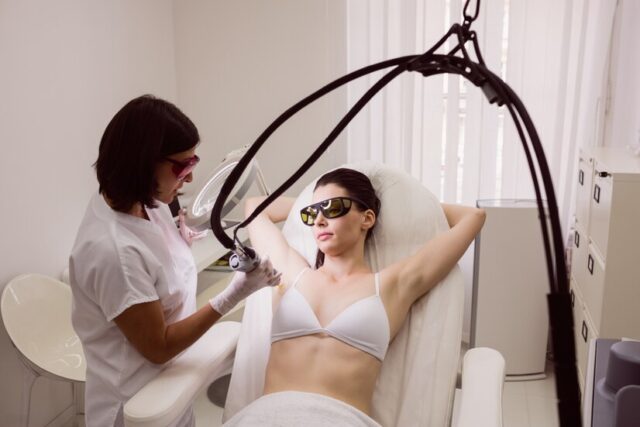 doctor-performing-laser-hair-removal-female-patient-skin_107420-65223